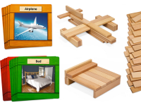 Orange and green cards with pictures of an airplane and a bed are next to constructed wooden versions of an airplane and a bed.