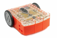 The Edison Bot has an orange bottom, a clear top with black buttons, and two grey and black wheels on the sides.