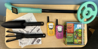 A blue and black metal detector, black rake and trowel, and pink and yellow walkie talkie are pictured.