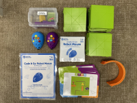 Green plastic squares and an orange plastic arch are pictured alongside a blue and purple mouse.